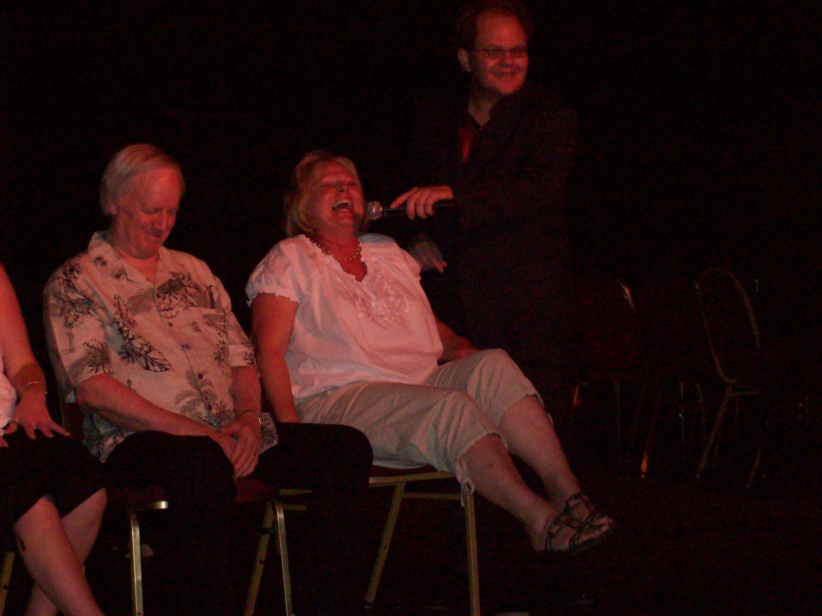 hypnotized woman laughs in comedy show Chis Cadys get hypnotized now playing in downtown reno nevada